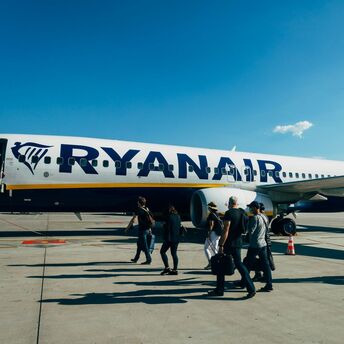 Passengers boarding a Ryanair aircraft on the apron
