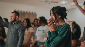 People taking part in a quiet prayer gathering indoors
