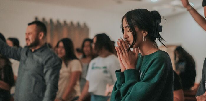 People taking part in a quiet prayer gathering indoors