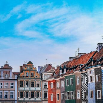Colourful townhouses in Poznań Old Town under blue sky