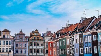 Colourful townhouses in Poznań Old Town under blue sky