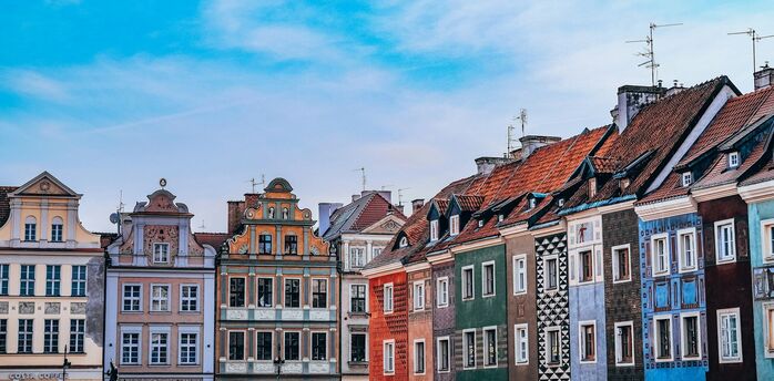 Colourful townhouses in Poznań Old Town under blue sky