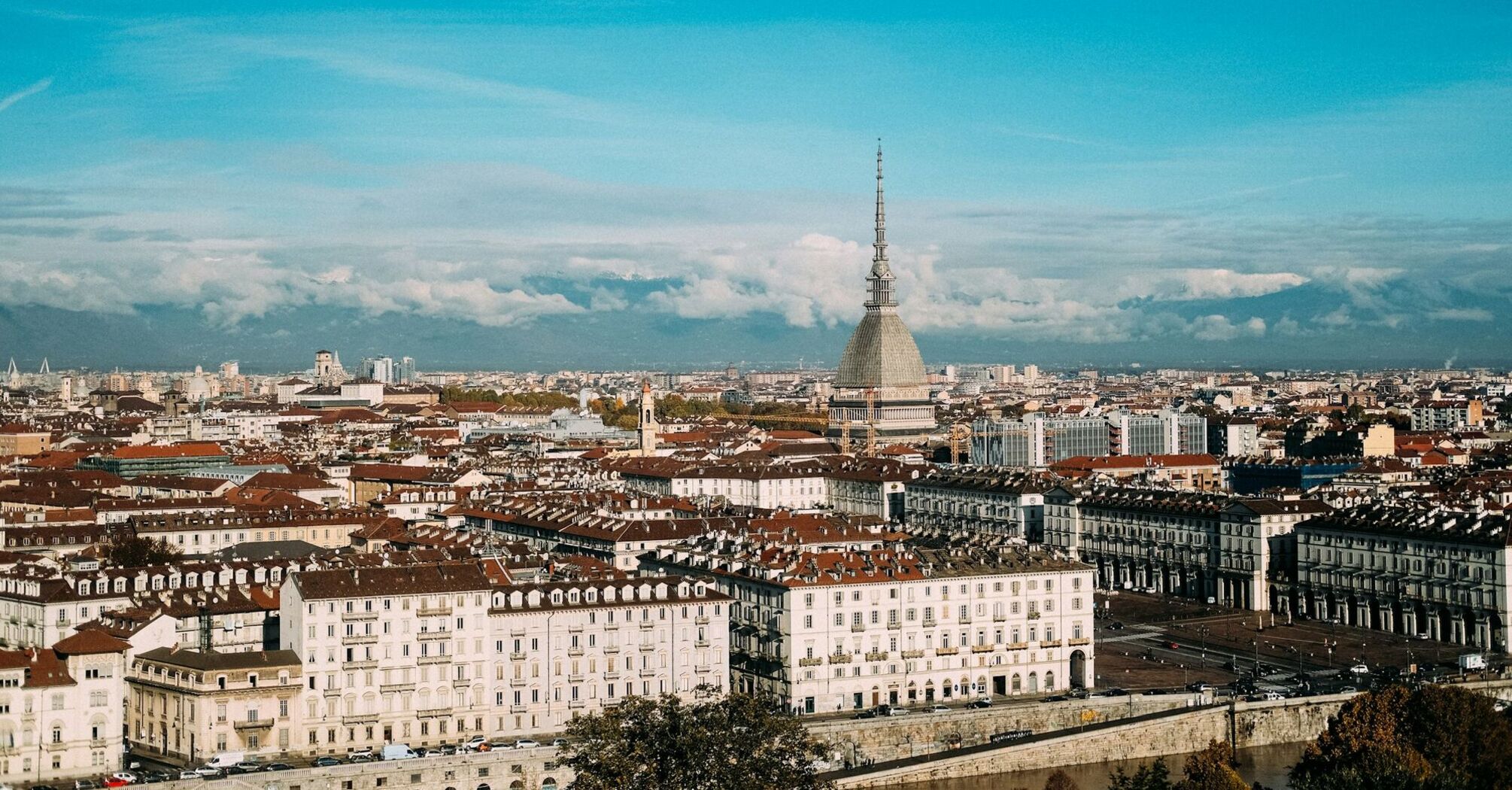 Panoramic view of Turin skyline with Mole Antonelliana and Alps in the background