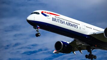 British Airways aircraft in flight against cloudy sky
