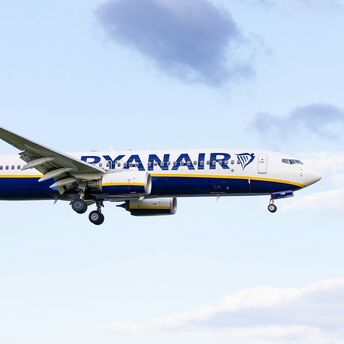 Ryanair Boeing 737 aircraft in flight against a cloudy sky