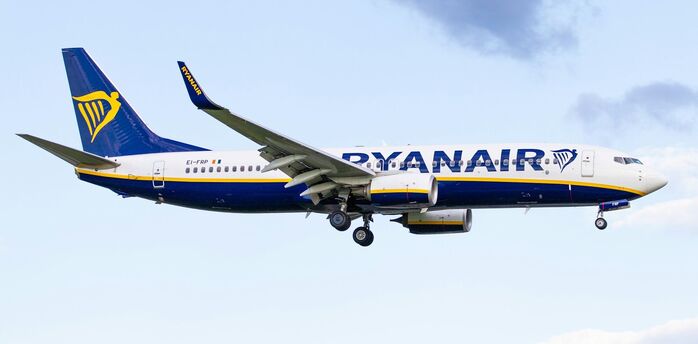 Ryanair Boeing 737 aircraft in flight against a cloudy sky