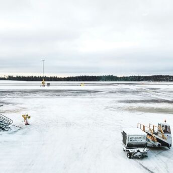 Snow-covered airport runway amid weather disruption