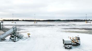Snow-covered airport runway amid weather disruption