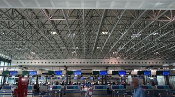 Airport check-in hall with passengers queueing during peak hours
