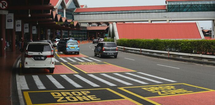 Airport drop-off zone with express lane and cars