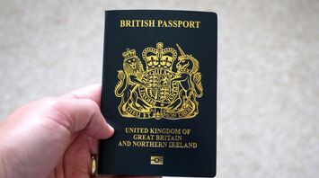 Hand holding a British passport