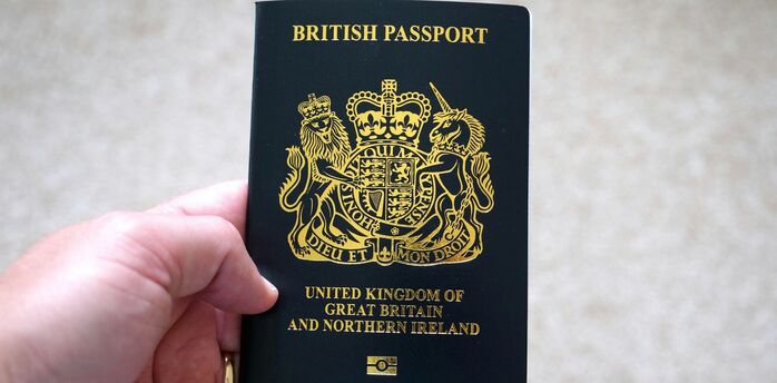 Hand holding a British passport