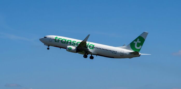 Transavia Boeing 737 aircraft in flight against blue sky