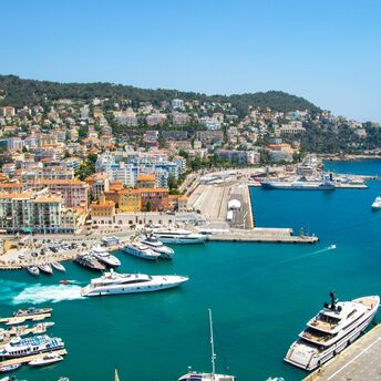 Aerial view of Nice harbour with yachts and hillside buildings on the French Riviera