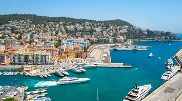Aerial view of Nice harbour with yachts and hillside buildings on the French Riviera