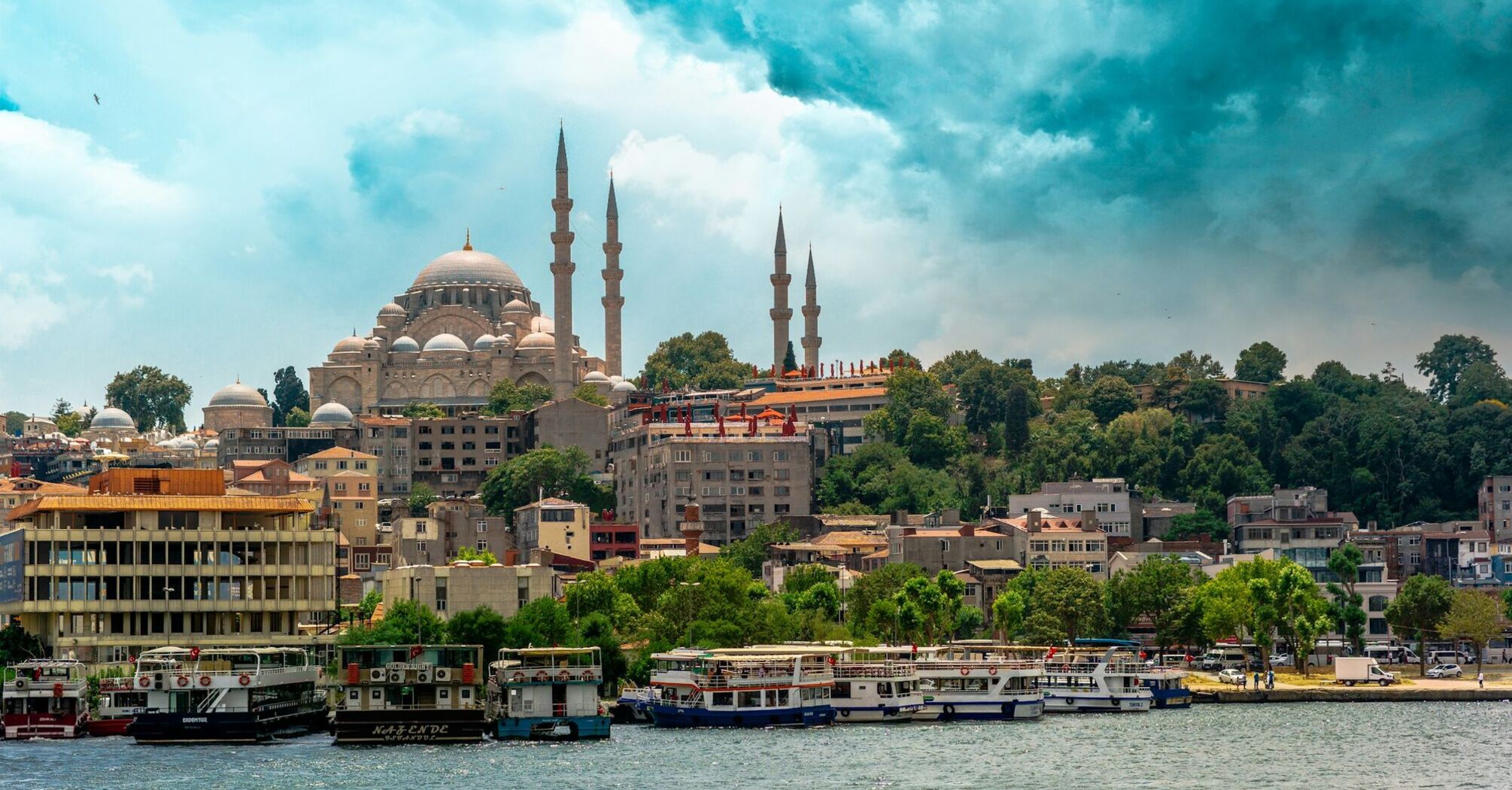 Istanbul skyline with mosque domes and boats along the waterfront
