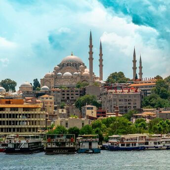 Istanbul skyline with mosque domes and boats along the waterfront