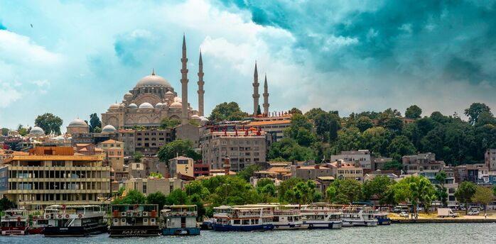 Istanbul skyline with mosque domes and boats along the waterfront