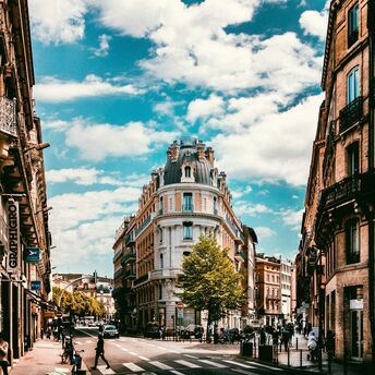 Street view of central Toulouse with historic buildings and pedestrians