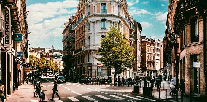 Street view of central Toulouse with historic buildings and pedestrians