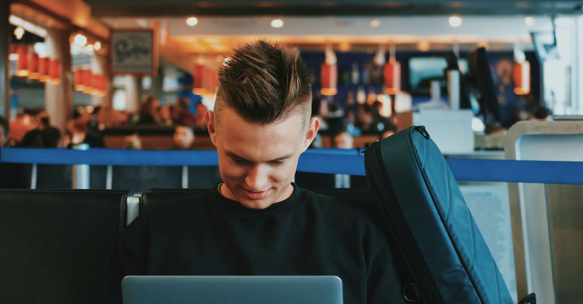 Passenger browsing travel content while waiting at airport