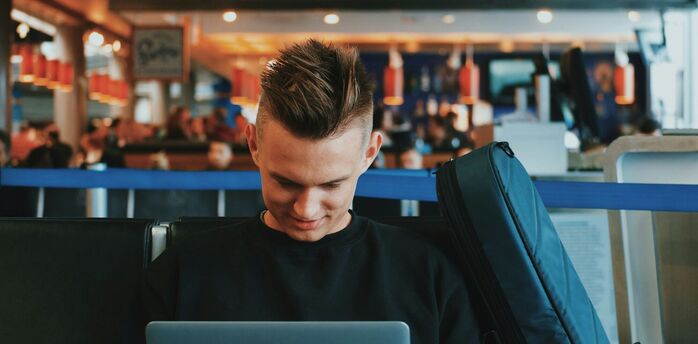 Passenger browsing travel content while waiting at airport