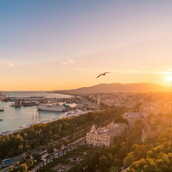 Aerial view of Málaga coastline and harbour at sunset