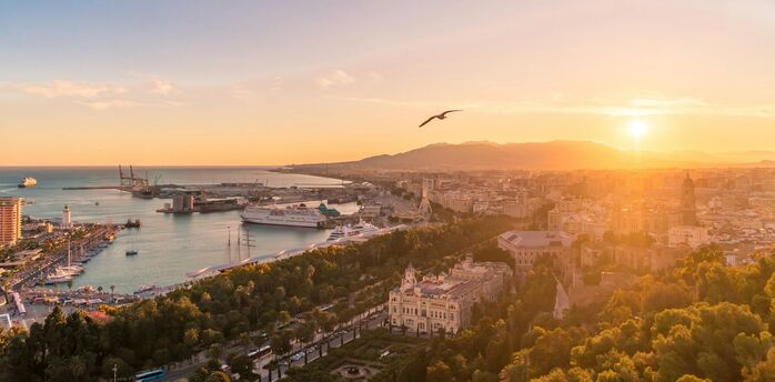 Aerial view of Málaga coastline and harbour at sunset