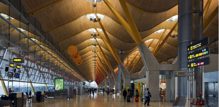 Madrid-Barajas Airport terminal interior with departure gates and passenger walkway