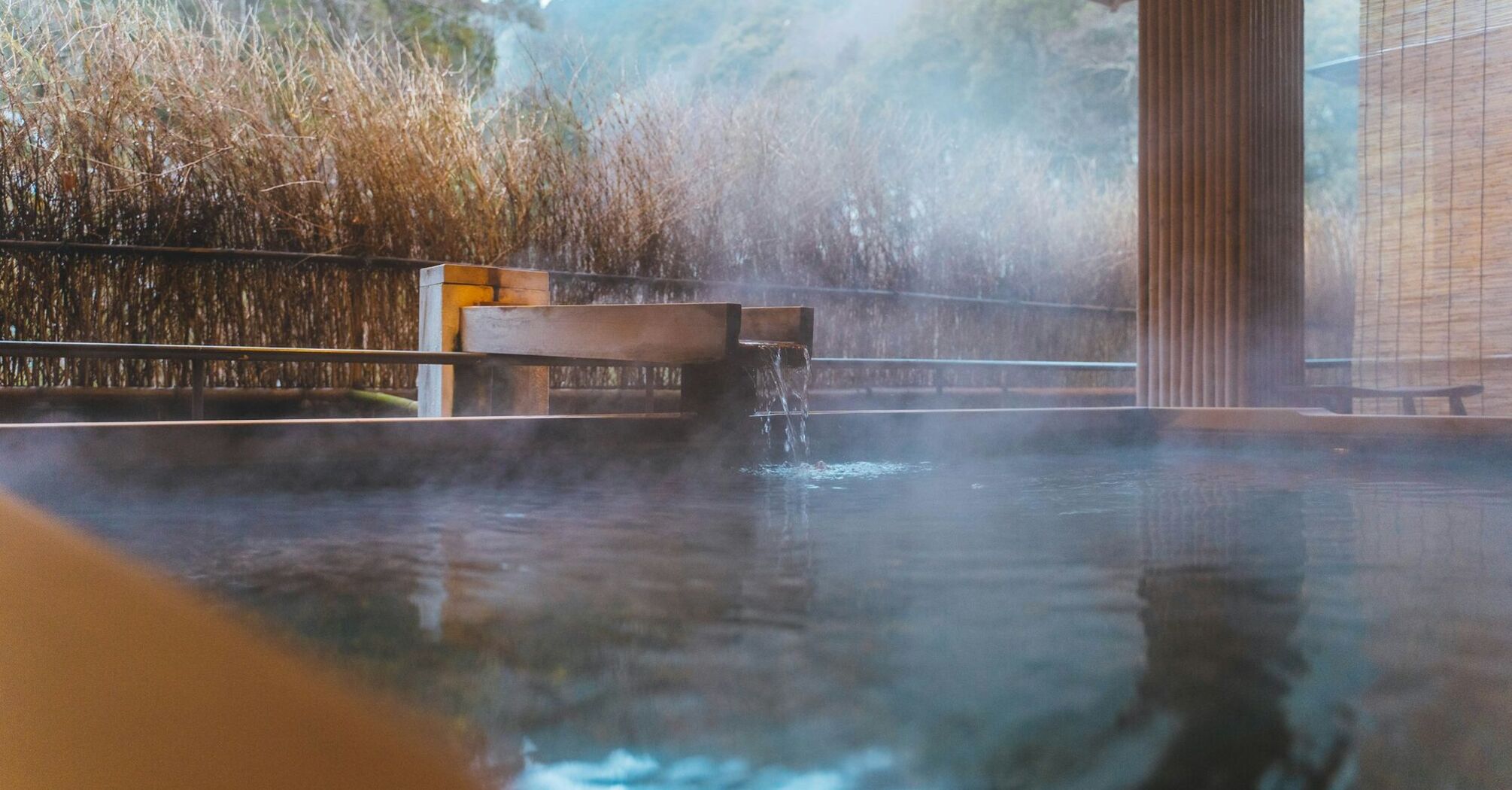 Outdoor hot spring bath surrounded by natural landscape