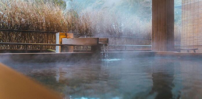 Outdoor hot spring bath surrounded by natural landscape