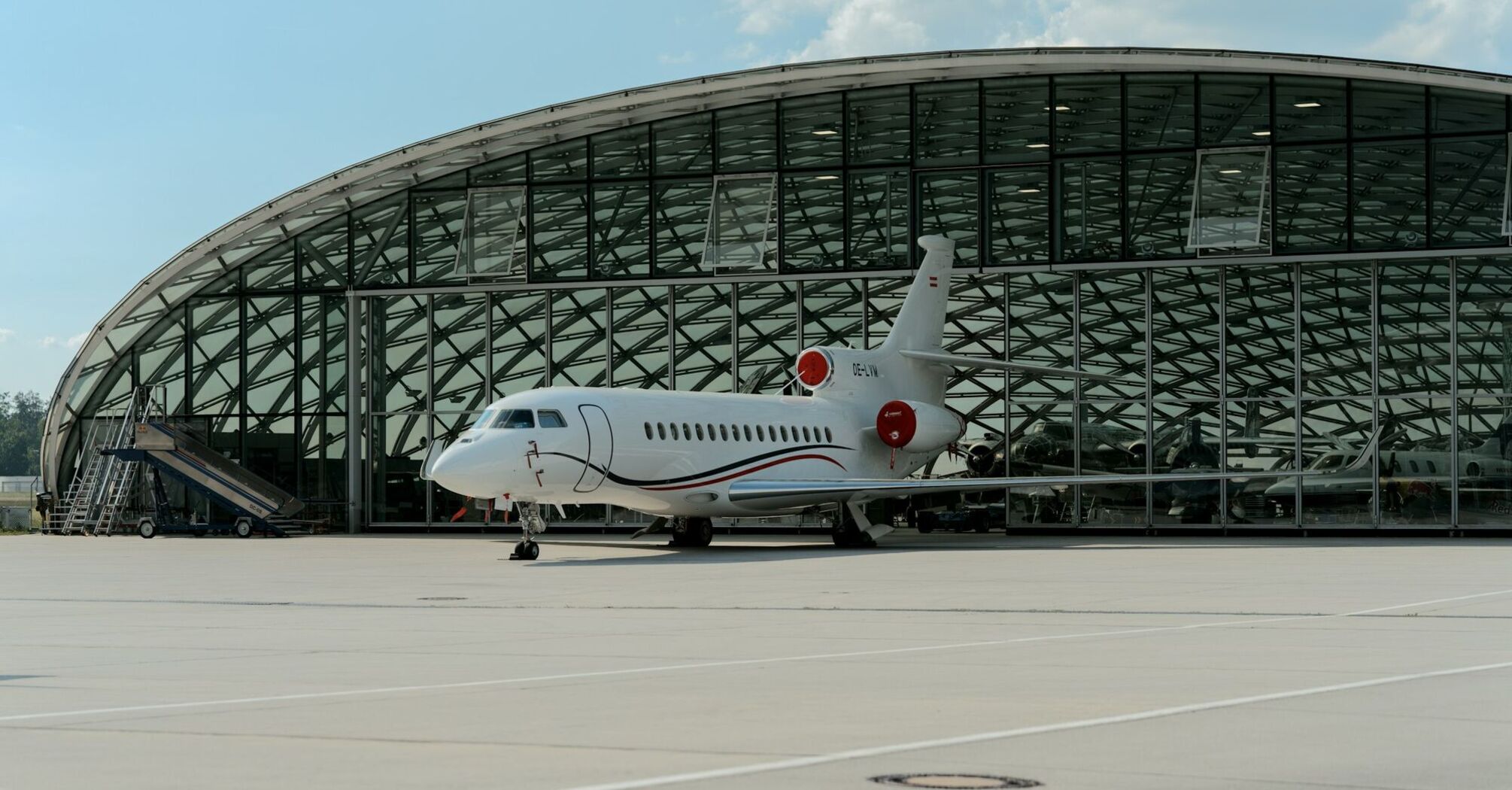Business jet parked outside Salzburg Airport hangar
