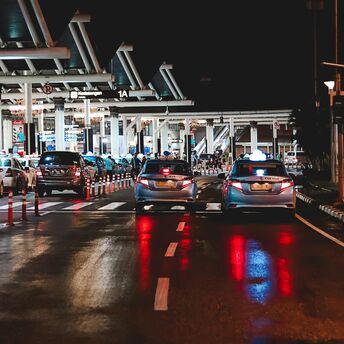 Cars queuing outside an airport terminal at night