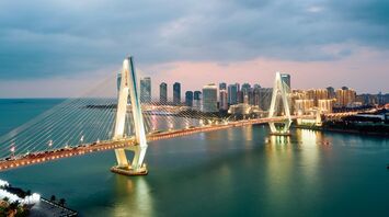 Haikou city skyline and bridge at dusk