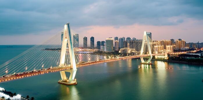 Haikou city skyline and bridge at dusk