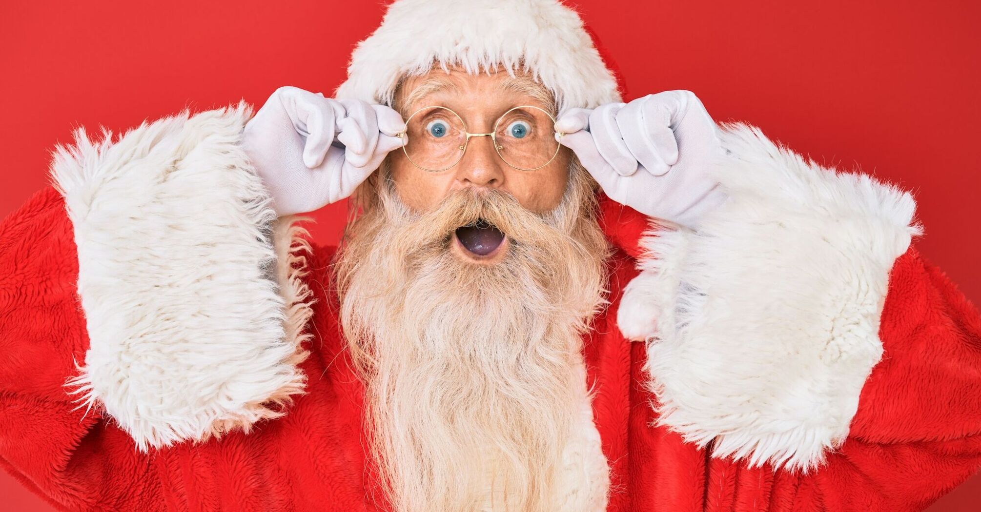 Santa Claus portrait with surprised expression on red background