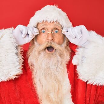 Santa Claus portrait with surprised expression on red background
