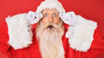 Santa Claus portrait with surprised expression on red background