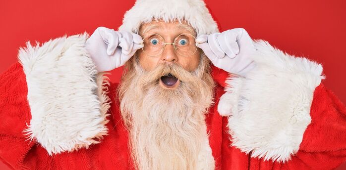Santa Claus portrait with surprised expression on red background