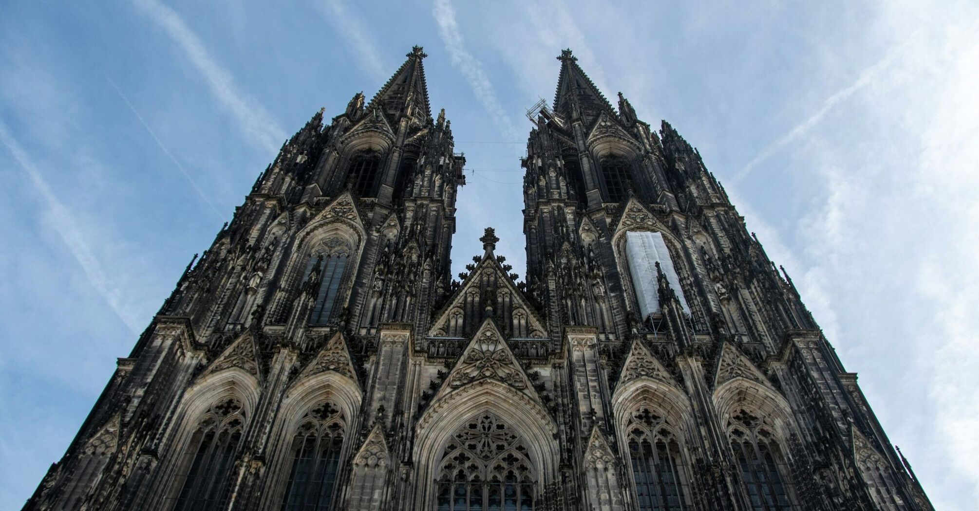 Cologne Cathedral Gothic façade with twin spires viewed from below