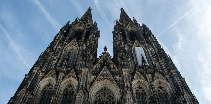 Cologne Cathedral Gothic façade with twin spires viewed from below