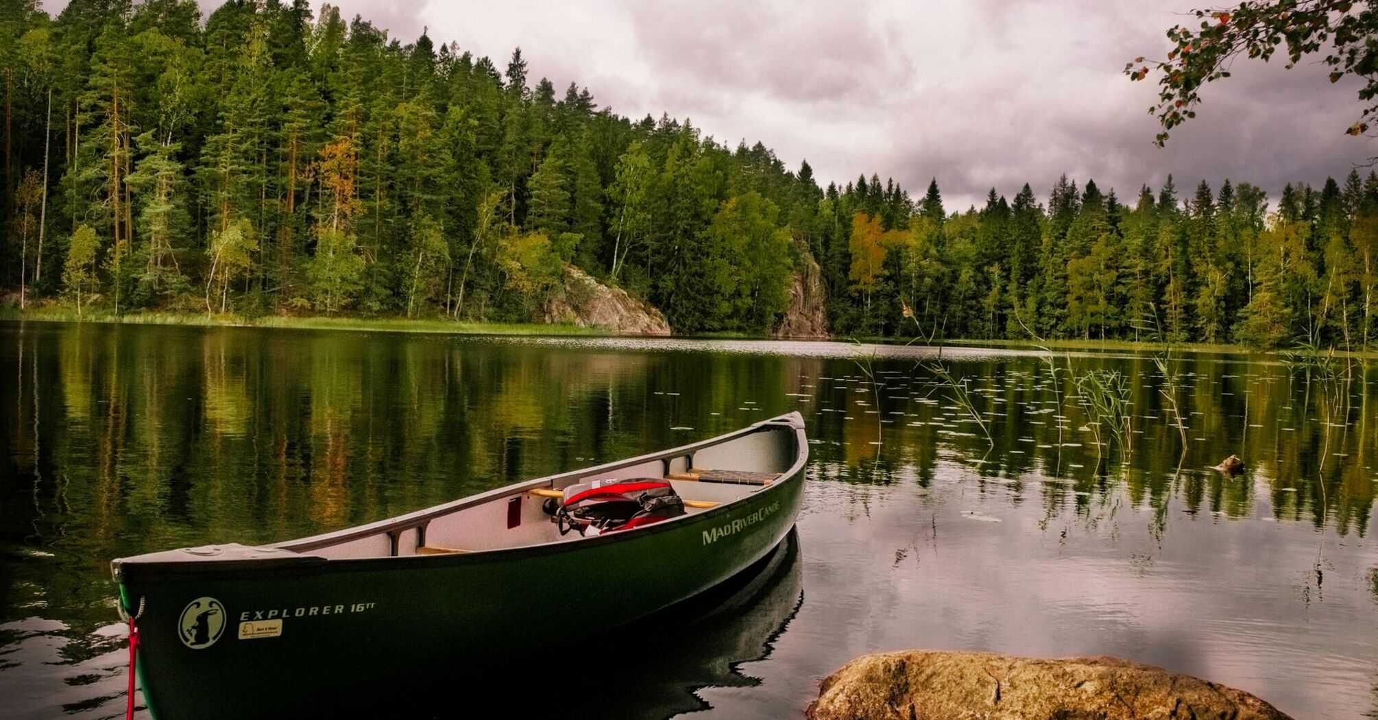 Canoe on a calm forest lake in Finland