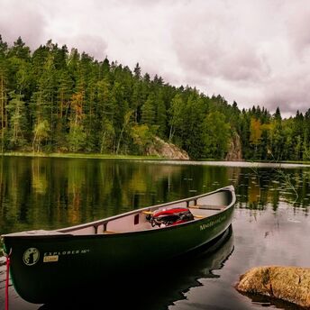 Canoe on a calm forest lake in Finland