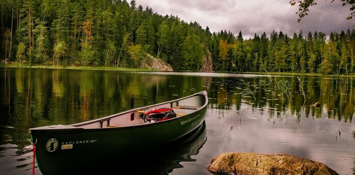 Canoe on a calm forest lake in Finland