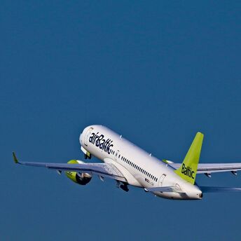 airBaltic Airbus A220 aircraft climbing after departure