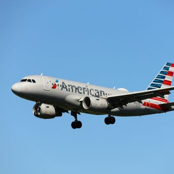 American Airlines aircraft flying in clear blue sky