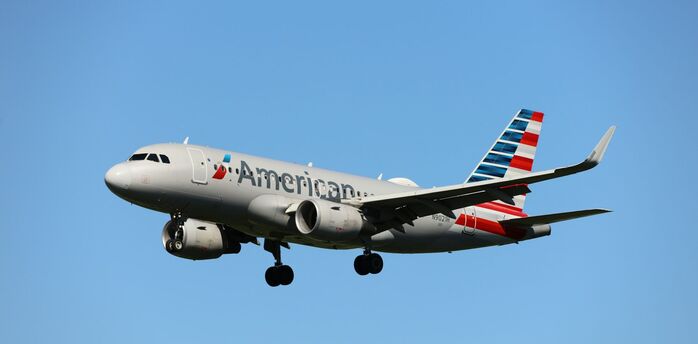 American Airlines aircraft flying in clear blue sky