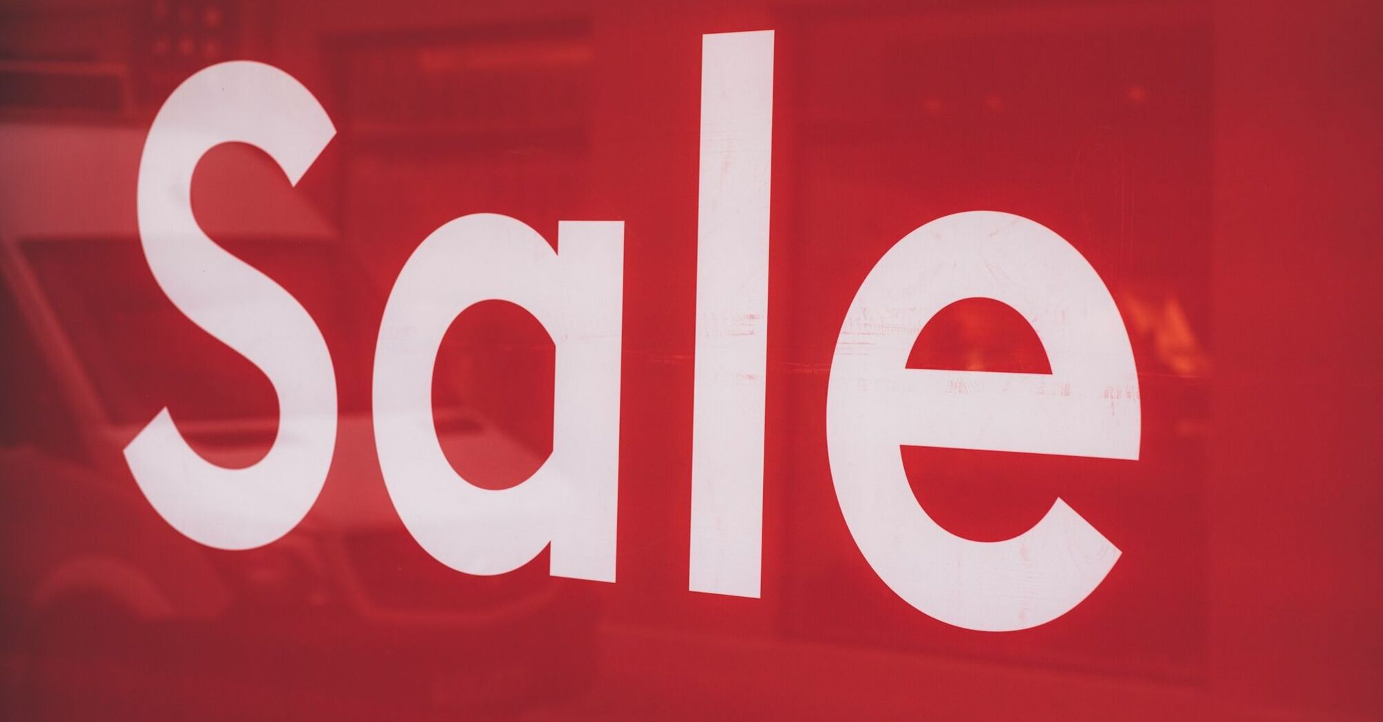 Red sale sign displayed on the window