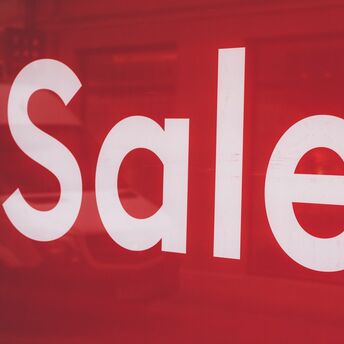 Red sale sign displayed on the window