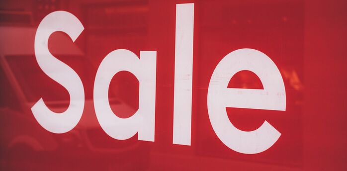 Red sale sign displayed on the window